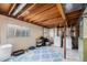 Unfinished basement space featuring exposed beams, washer and dryer, and two windows at 20451 Kelly Pl, Denver, CO 80249