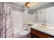 Bright bathroom featuring a shower over tub and large vanity mirror at 20451 Kelly Pl, Denver, CO 80249