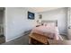 Bright bedroom with light blue walls, plush carpet and a wooden detailed bed at 20451 Kelly Pl, Denver, CO 80249