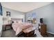 Cozy bedroom features a large window, a comfortable bed, and stylish furnishings at 20451 Kelly Pl, Denver, CO 80249