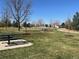 Community park featuring picnic benches, open green space, and mature trees on a sunny day at 20451 Kelly Pl, Denver, CO 80249