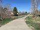 Concrete community trail surrounded by grass and trees on a clear day at 20451 Kelly Pl, Denver, CO 80249