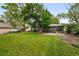 Well-maintained backyard showcasing a large lawn, trees and patio at 5436 E Atlantic Pl, Denver, CO 80222