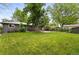 Spacious backyard with lush green grass, mature trees and partial fencing at 5436 E Atlantic Pl, Denver, CO 80222