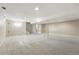 Spacious finished basement area featuring neutral carpet, overhead lighting, and utility access at 5436 E Atlantic Pl, Denver, CO 80222