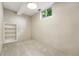 Finished basement room featuring neutral carpet, overhead lighting, and a window at 5436 E Atlantic Pl, Denver, CO 80222
