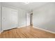 Neutral bedroom with hardwood floors and closet and views into the hallway at 5436 E Atlantic Pl, Denver, CO 80222