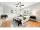 Cozy bedroom featuring hardwood floors, neutral paint, and two bright windows at 5436 E Atlantic Pl, Denver, CO 80222