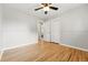 Empty bedroom featuring hardwood floors, neutral paint, ceiling fan and closet at 5436 E Atlantic Pl, Denver, CO 80222