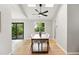 Bright dining room with skylights, hardwood floors, modern table and chairs, and large windows to the outside at 5436 E Atlantic Pl, Denver, CO 80222
