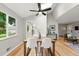 Bright dining room with skylights, hardwood floors, modern table and chairs, and neutral paint colors at 5436 E Atlantic Pl, Denver, CO 80222