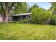 A cozy home featuring a lush green lawn and mature trees at 5436 E Atlantic Pl, Denver, CO 80222