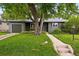 Charming home with a well-manicured lawn and beautiful landscaping at 5436 E Atlantic Pl, Denver, CO 80222