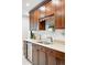 Kitchen featuring granite countertops, stainless steel sink, wood cabinets, and recessed lighting at 5436 E Atlantic Pl, Denver, CO 80222