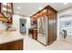 Cherry cabinets, stainless steel appliances, granite countertops in this updated kitchen with a view to the dining room at 5436 E Atlantic Pl, Denver, CO 80222