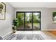 Bright living room features glass doors leading to backyard, neutral paint, and tiled floors at 5436 E Atlantic Pl, Denver, CO 80222