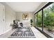 Sun room featuring large sliding glass doors, tile floor, and gray easy chair with an accent rug at 5436 E Atlantic Pl, Denver, CO 80222