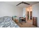 Bright bedroom featuring carpet, ceiling fan, small desk, and ensuite bathroom at 13456 Via Varra # 225, Broomfield, CO 80020