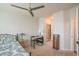 Bright bedroom featuring carpet, ceiling fan, small desk, and ensuite bathroom at 13456 Via Varra # 225, Broomfield, CO 80020