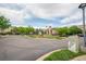 View of the entrance to the Vantage community, featuring a circular drive and lush landscaping at 13456 Via Varra # 225, Broomfield, CO 80020