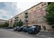 Apartment building exterior with brick and siding, featuring multiple levels, balconies, and parking at 13456 Via Varra # 225, Broomfield, CO 80020