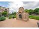 Outdoor stone fireplace feature with seating in the common area near the grilling stations at 13456 Via Varra # 225, Broomfield, CO 80020