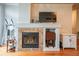 Living room showcasing an inviting fireplace with decorative tile surround and a mantel at 13456 Via Varra # 225, Broomfield, CO 80020
