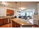 Spacious kitchen with granite countertops, stainless steel appliances, hardwood floors, and open layout to the living area at 13456 Via Varra # 225, Broomfield, CO 80020