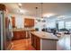 Bright kitchen featuring stainless steel appliances, a breakfast bar, hardwood floors and an open floor plan at 13456 Via Varra # 225, Broomfield, CO 80020