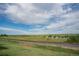 Scenic view of the community landscape with a railway, lush vegetation, and open sky at 13456 Via Varra # 225, Broomfield, CO 80020