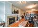 Comfortable living room featuring a cozy fireplace with tile surround and access to open-concept kitchen at 13456 Via Varra # 225, Broomfield, CO 80020