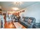 Open-concept living room flows into the kitchen with hardwood floors and comfortable seating at 13456 Via Varra # 225, Broomfield, CO 80020