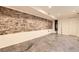 Spacious basement area with exposed brick wall and a concrete floor at 3521 Osage St, Denver, CO 80211
