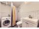 Compact bathroom and laundry room design with a tiled shower, modern fixtures, and a washer/dryer combo at 3521 Osage St, Denver, CO 80211
