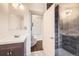 Bathroom featuring a modern sink and a glass-enclosed shower with stylish tile work at 3521 Osage St, Denver, CO 80211
