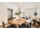 Open-concept dining area featuring hardwood floors, a stylish table setting, and views of the living room at 3521 Osage St, Denver, CO 80211