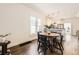 Charming dining area with a wooden table, black chairs, and a view to the open kitchen at 3521 Osage St, Denver, CO 80211