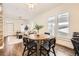 Bright dining area with an open layout, hardwood floors, and views to the living room and kitchen at 3521 Osage St, Denver, CO 80211