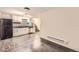 Kitchen featuring white cabinets, a black marbled countertop, and stainless steel appliances with connecting room at 3521 Osage St, Denver, CO 80211