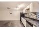 Kitchen featuring white cabinets, a black marbled countertop, and stainless steel appliances at 3521 Osage St, Denver, CO 80211