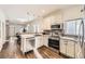 Modern kitchen featuring stainless steel appliances, granite countertops, and open layout to the living areas at 3521 Osage St, Denver, CO 80211