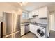 Modern kitchen with stainless steel appliances, granite countertops, and tile backsplash at 3521 Osage St, Denver, CO 80211