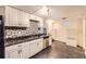 Open concept kitchen with white cabinets, a black marbled countertop, and stainless steel appliances at 3521 Osage St, Denver, CO 80211