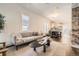 Bright living room with hardwood floors, a comfortable sofa, and an open view to the kitchen at 3521 Osage St, Denver, CO 80211
