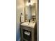 Stylish bathroom with a square sink, modern faucet, and storage for additional toilet paper at 13640 Garfield St # A, Thornton, CO 80602