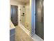 Modern bathroom showcases a glass shower, sleek fixtures, and stylish gray door and cabinet at 13640 Garfield St # A, Thornton, CO 80602