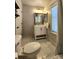 Bright bathroom with a vanity, toilet, and shower, featuring a decorative window covering at 13640 Garfield St # A, Thornton, CO 80602