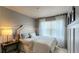 Cozy bedroom with a comfortable bed, stylish furnishings, and a bright window with sheer curtains at 13640 Garfield St # A, Thornton, CO 80602