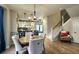 Open-concept dining area with a stylish chandelier, hardwood floors, and seamless flow to the kitchen at 13640 Garfield St # A, Thornton, CO 80602