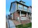 Side view of a charming two-story home with a stone facade and covered front porch at 13640 Garfield St # A, Thornton, CO 80602